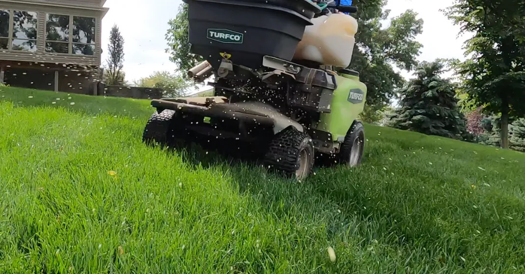 Roper Lawn Care technician treating a healthy Bermuda lawn at a Memphis, TN home
